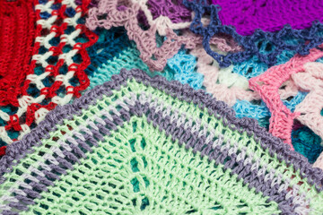 background of handmade multicolor crochet squares with different crochet stiches
