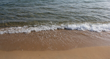 Soft beautiful ocean wave on sandy beach. Background