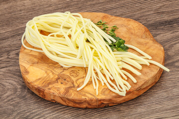 Chechil spaghetti cheese over board
