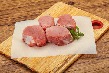 Raw pork medallion served rosemary