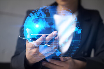 Businesswoman using smart phone in office. International business affairs with world map. Double...