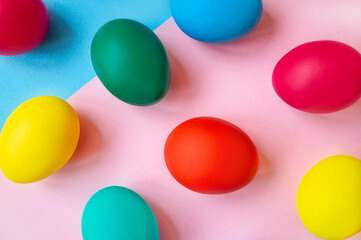 colorful easter eggs on pink background with copy space. Easter background