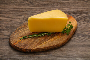 Hard cheese piece served rosemary