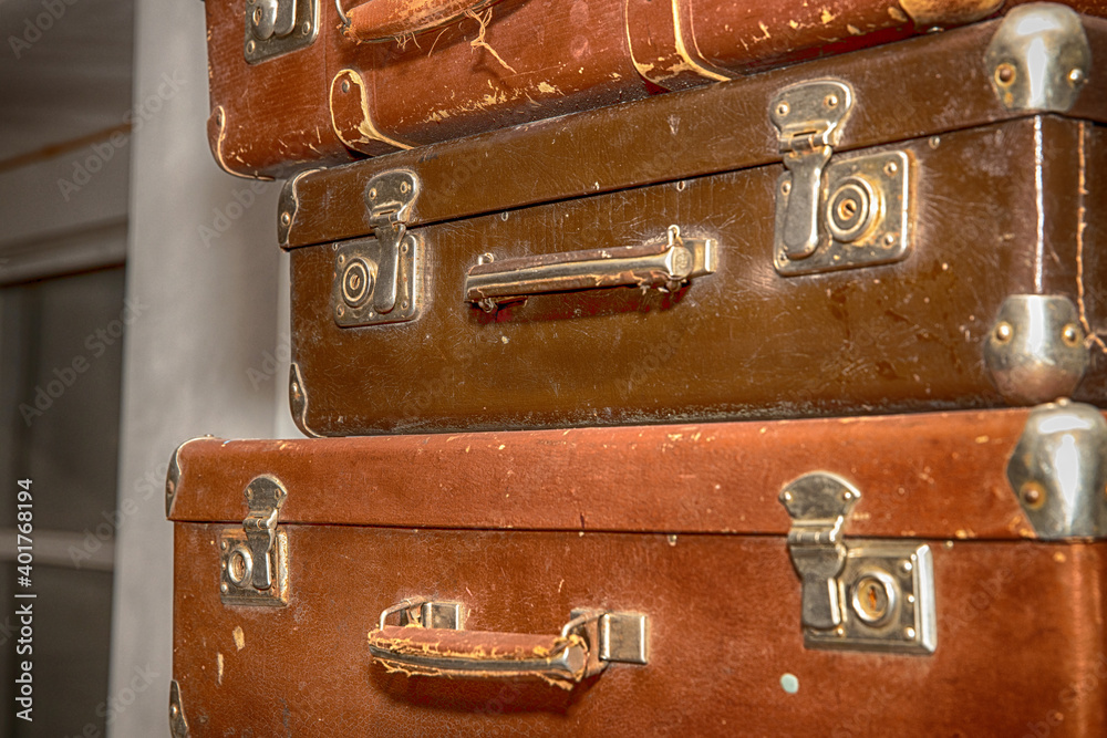 Poster stack of old retro suitcases close up