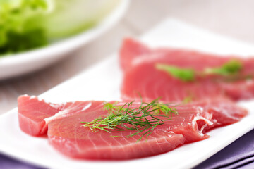 Raw Tuna steak. Raw fish on a plate.