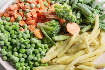 Mix of different frozen vegetables top view.