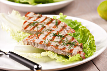 Grilled tuna with salad on a plate ready to eat.