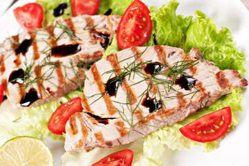 Grilled tuna with salad on a plate ready to eat.