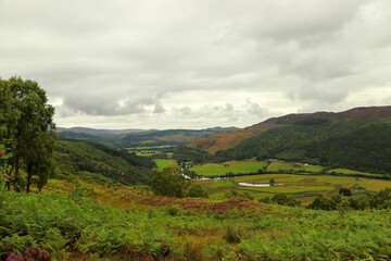Fototapeta na wymiar A view down from the hills of Scotland to the glens, rivers and lochs below