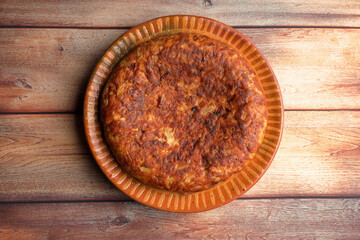 Spanish omelette on wooden background top view