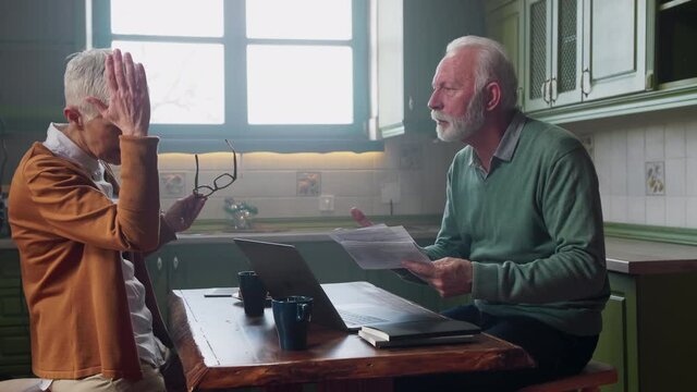 Elderly couple arguing about finances