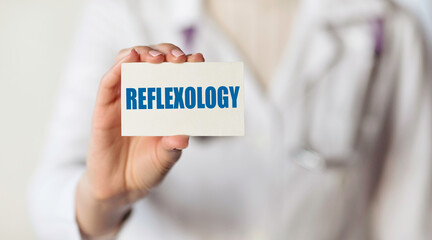 REFLEXOLOGY. Card with text in hand of Medical Doctor.