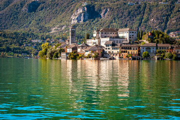 The world famous Orta San Giulio island, in the Orta Lake (Piedmont, Northern Italy) seen from the city of Orta, along the lake shores. It is UNESCO World Heritage Site.