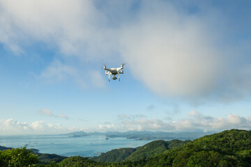 Fototapeta na wymiar Flying drone taking photo of landscape with sea and mountains
