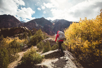 Fototapeta na wymiar Backpacker hiking in high altitude winter mountains