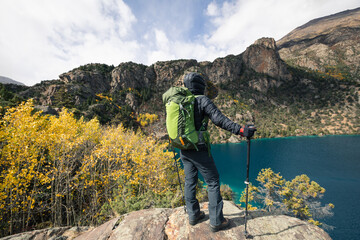 Backpacker hiking  in high altitude winter mountains