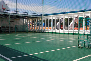 Staying fit on multi purpose sports court on classic cruiseship or cruise ship liner on outdoor deck
