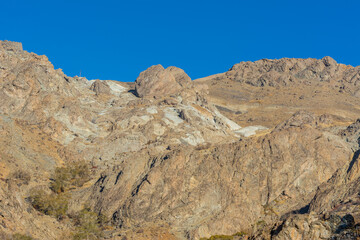 Barren mountain in Darband valley in autumn in the morning against blue sky in the Tochal mountain. A popular recreational region for Tehran's residents