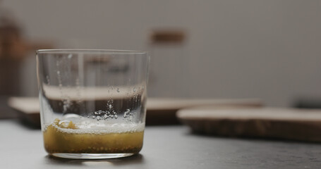 lulo fruit pulp in tumbler glass on concrete countertop