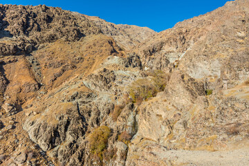 Barren mountain in Darband valley in autumn in the morning against blue sky in the Tochal mountain. A popular recreational region for Tehran's residents