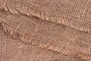 The texture of an uneven crumpled, roughly woven burlap.