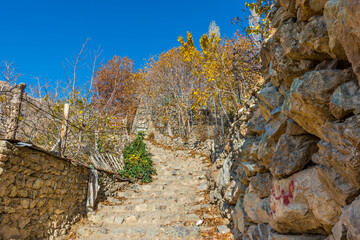 Stone street in Darband valley in the morning in autumn to the Tochal mountain. A popular recreational region for Tehran's residents