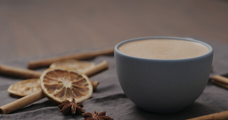 cocoa drink in blue cup from walnut table with christmas decorations and copy space