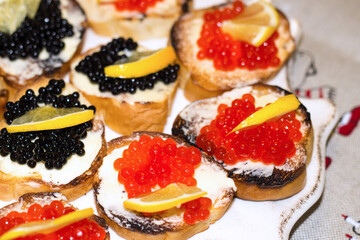 Sandwiches with caviar. Treats on the festive table. A delicacy treat for Christmas and New Years. Flat layout. Top view.