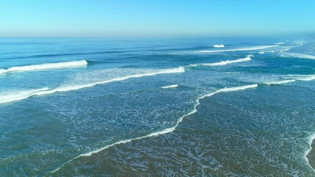 At the west seacoast of Portugal, waves surge against the seacoast consecutively in a row.
