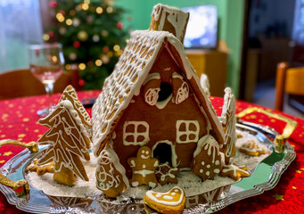 Gingerbread house decoration on the silver plate in the Christmas theme.