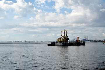 Offshore construction vessel working hauling sand