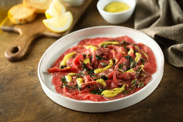 Homemade beef carpaccio with mustard sauce