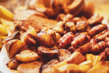 Selective focus Sunday dinner of mixed roast beef with Potatoes, Pigs in blankets, Sausages wrapped in bacon and Yorkshire pudding,Home made sun day brunch or lunch with mixed roast,English traditions