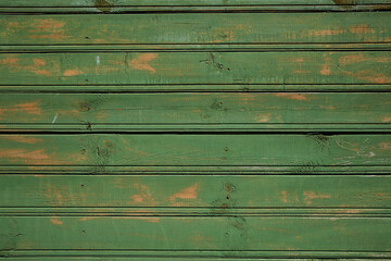 Wooden textured background. Old peeling green painted boards with scratches