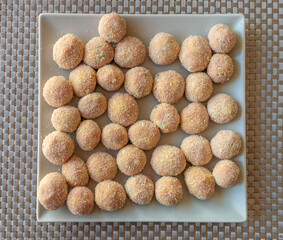 Meatballs coated in breadcrumbs on a square plate