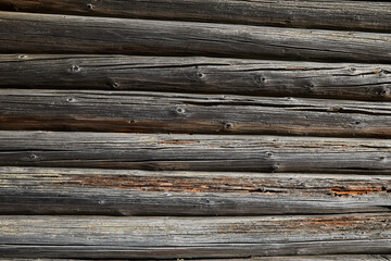 Wood texture, wooden background. Old wooden logs with cracks and scratches