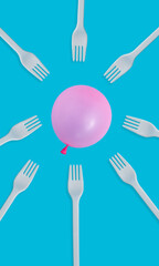 Creative business concept with pink balloon flying and kitchen forks on pastel blue background. Flat lay design