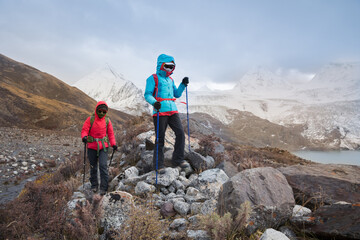 Fototapeta premium Two women hikers hiking in winter mountains