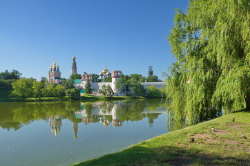 Fototapeta na wymiar View of the Novodevichy monastery and the Big Novodevichy pond on a summer day. Moscow, Russia