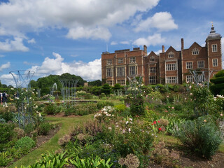 A majestic view of Hatfield House in Hertfordshire towering over manicured lawns and gardens