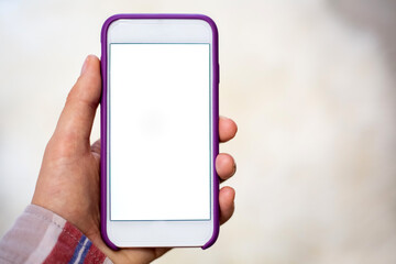 Close-Up of female hand holding smartphone with white mockup on screen, white background.