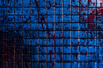 Bloody background. The dirty tile wall is stained with blood. A gloomy morgue room with a blue...