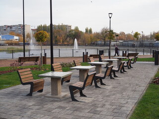 Concrete chess table for outdoor play. Chess playground in the city park. Contemporary concrete architecture and public space decoration
