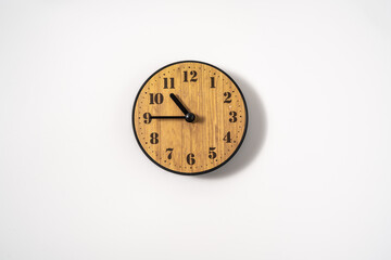 wood office wall clock with white dial on white background. wall clock on white background, top...