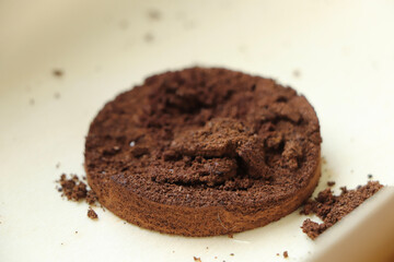 Coffee ground cylinder lying in a bamboo pot