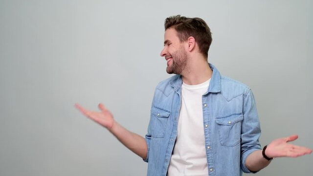 Confused bearded young man gesturing i don't know or have no idea