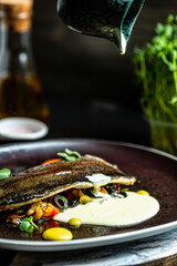 Grilled trout, carp and mullet. Juicy delicacy fish with fried vegetables. Balkan cuisine. close-up, on plate. vertical image, place for text