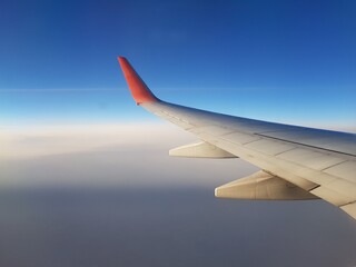 Airplane wing in blue sky