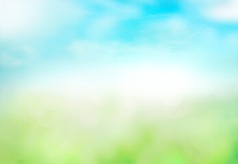 Fototapeta na wymiar Green grass blue sky blurred bokeh background.Abstract spring summer nature backdrop,de focused illustration.