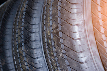 Protector close-up of new winter tires. on black background. New tires background. Close up tire profile car tires. Selective focus.